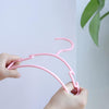 100 Ganchos plásticos para ropa de niño color rosa