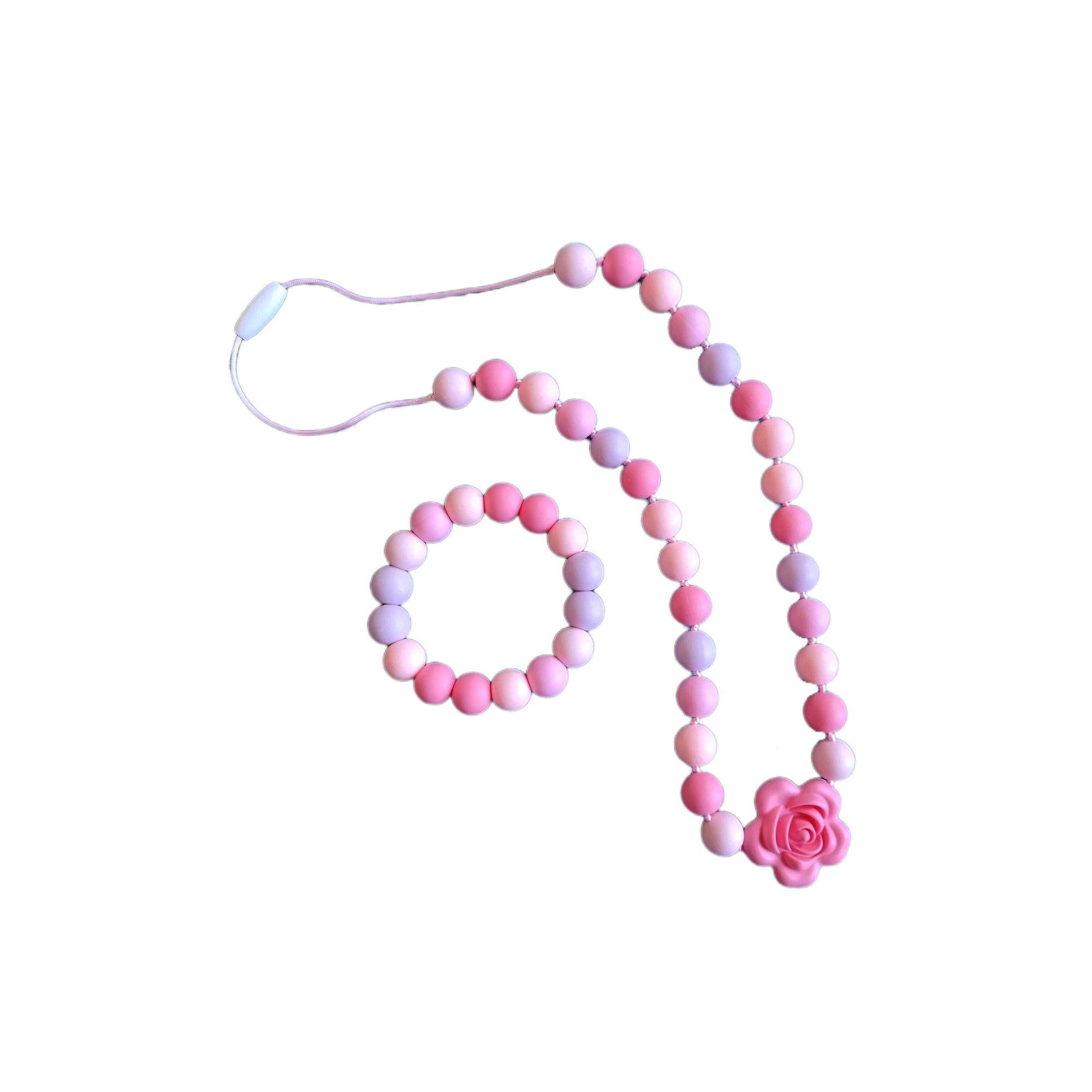 Collar y pulsera rosadas de cuentas de silicona con decoración de flor